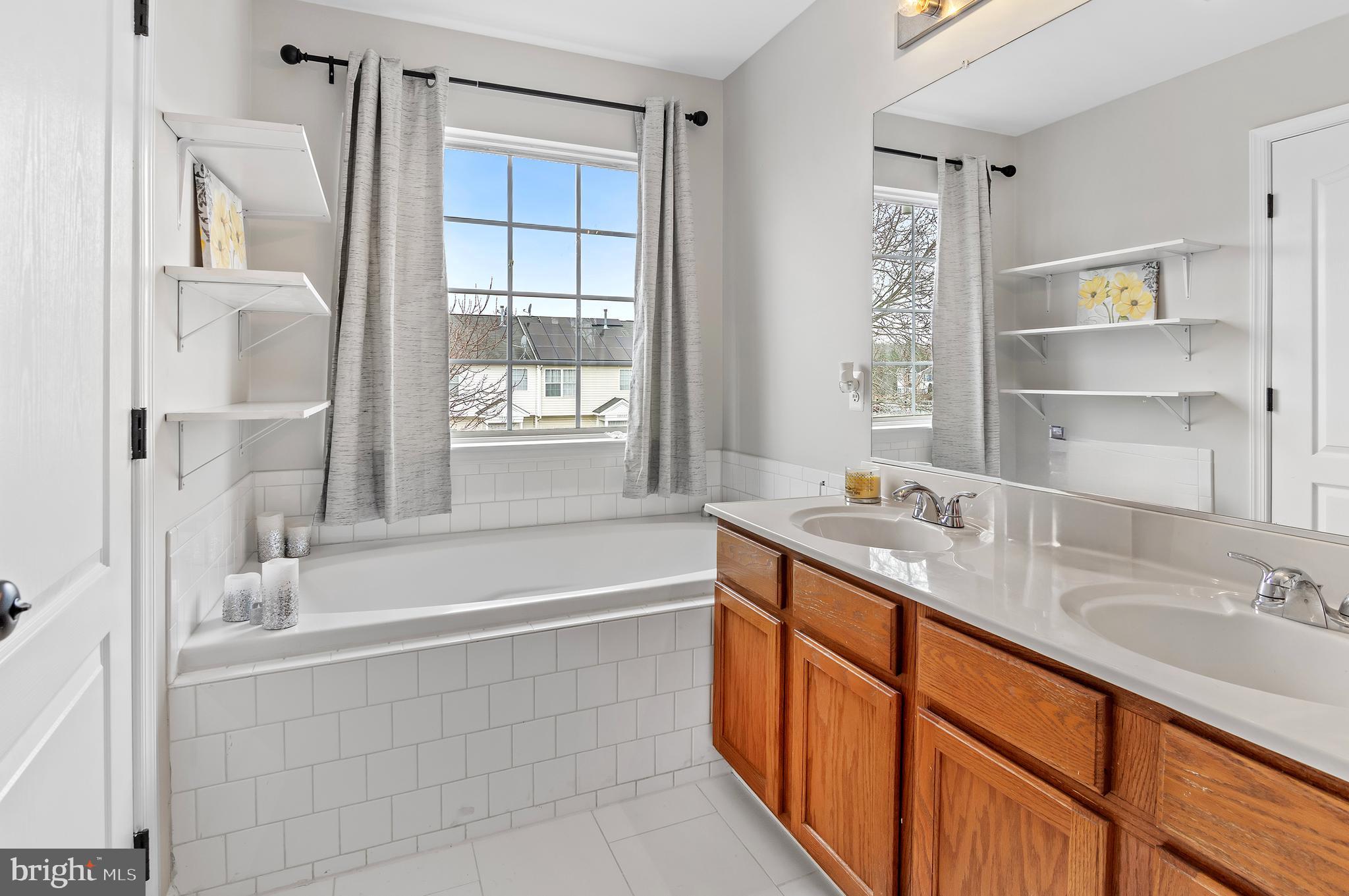 15511 Wylie Road Brandywine, MD 20613 - Photo 20 of 32 a bathroom with a granite countertop sink mirror bathtub and shower