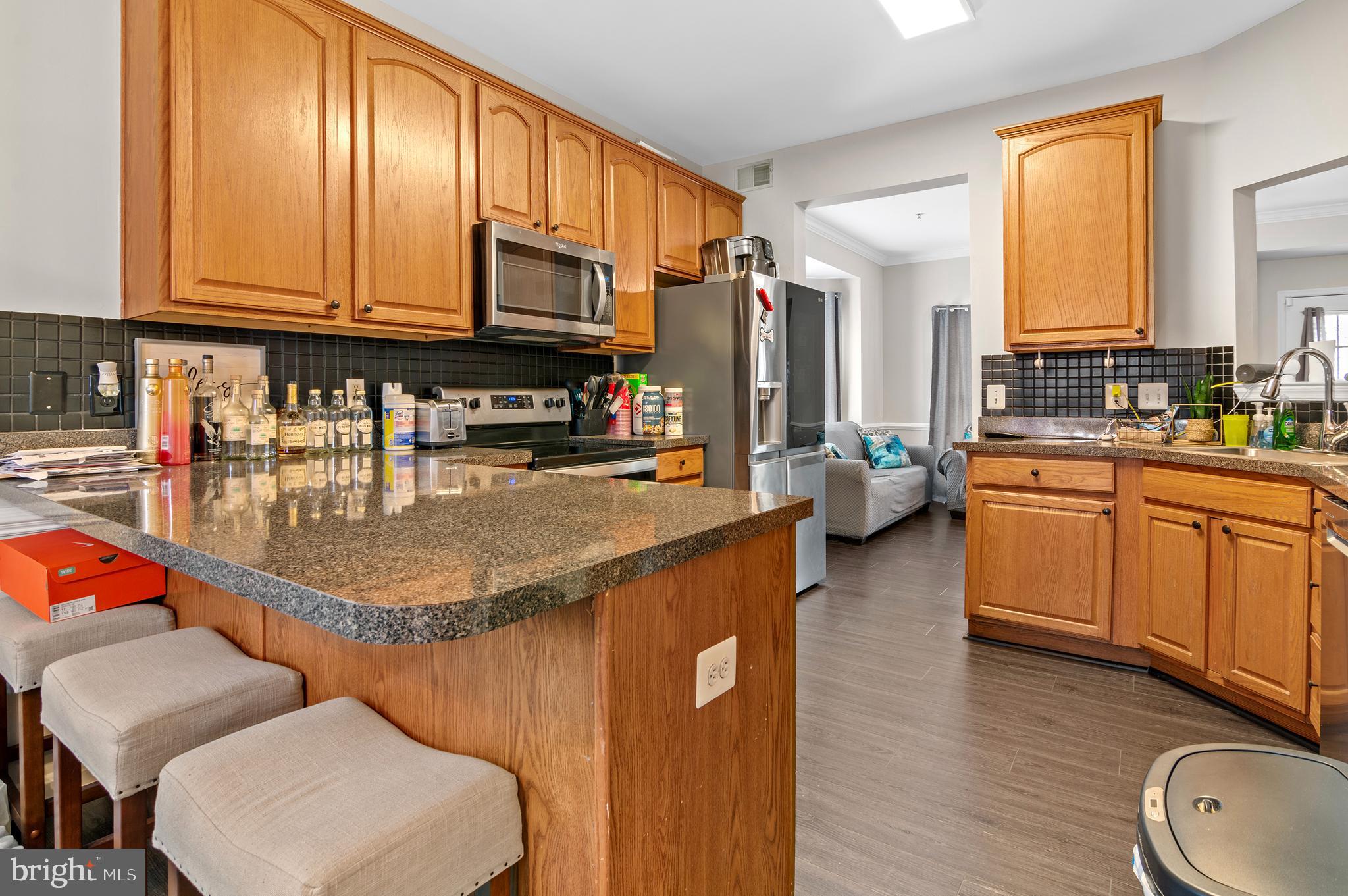15511 Wylie Road Brandywine, MD 20613 - Photo 8 of 32 a kitchen with stainless steel appliances granite countertop a sink a stove counter space and cabinets