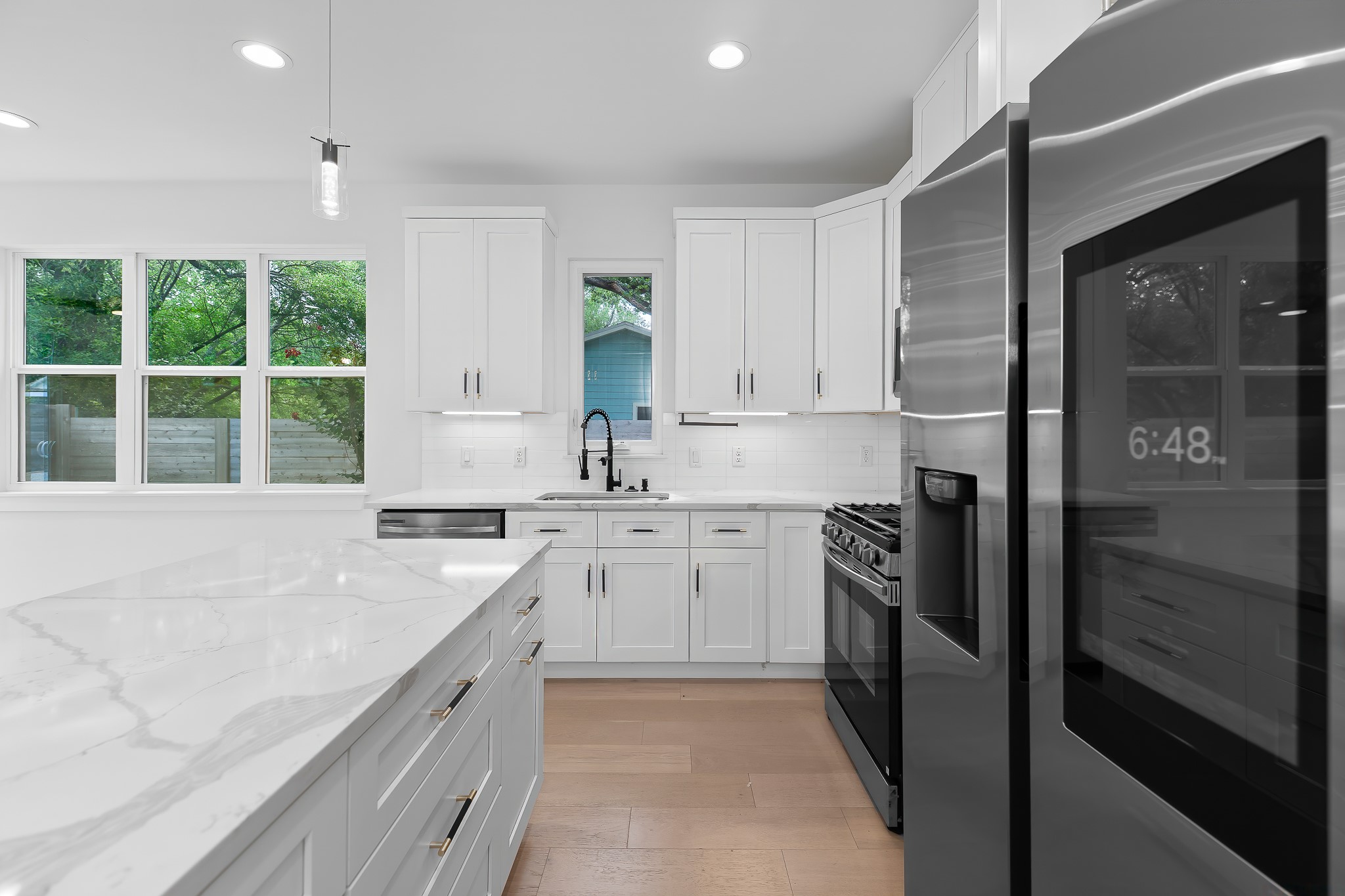5305 Ledesma Road, Unit 4 Austin, TX 78721 - Photo 7 of 40 Gleaming marble countertops and pristine white cabinetry define this modern culinary space.