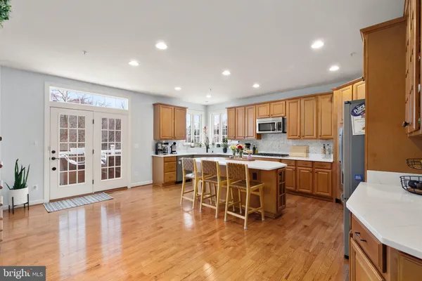 a kitchen with a dining table chairs refrigerator and cabinets