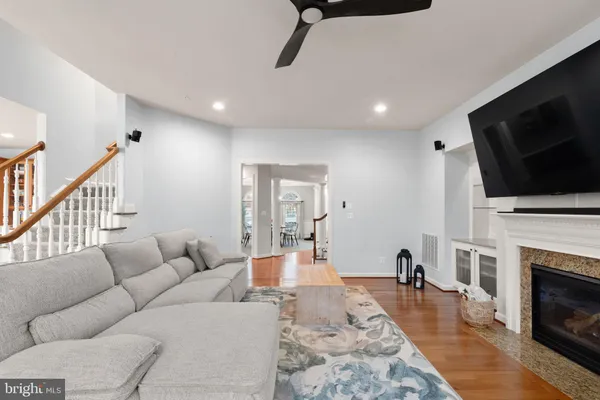 a living room with fireplace furniture and a flat screen tv