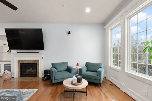 a living room with fireplace furniture and a flat screen tv