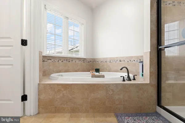a bathroom with bathtub sink