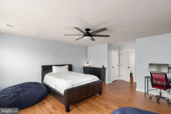 a bed room with a bed and a chair