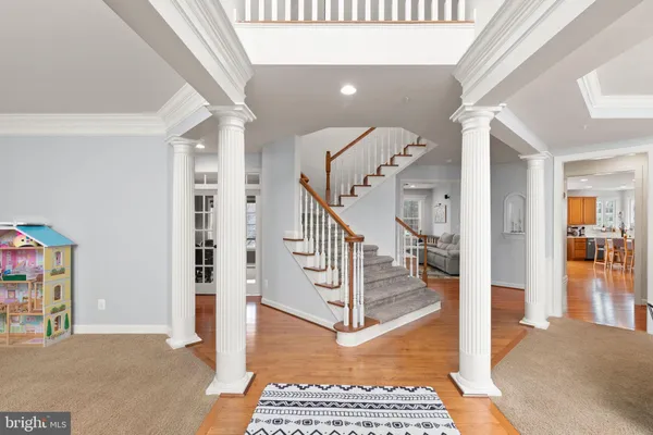 a view of entryway and hall with wooden floor