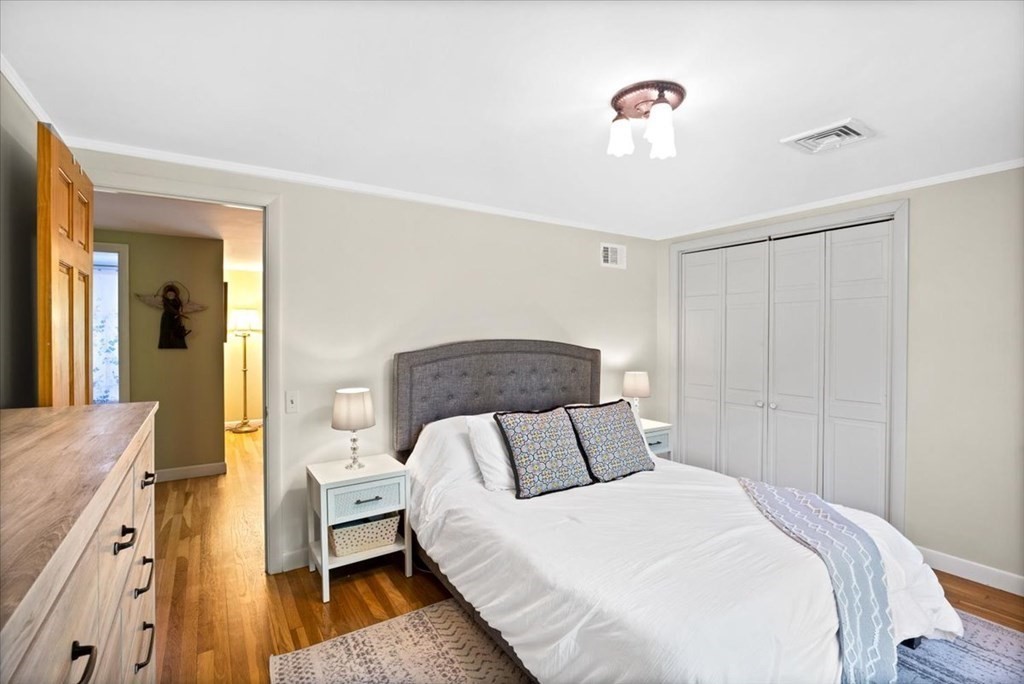 280 Broadway Hanover, MA 02339 - Photo 27 of 37 a bedroom with a bed and a chandelier