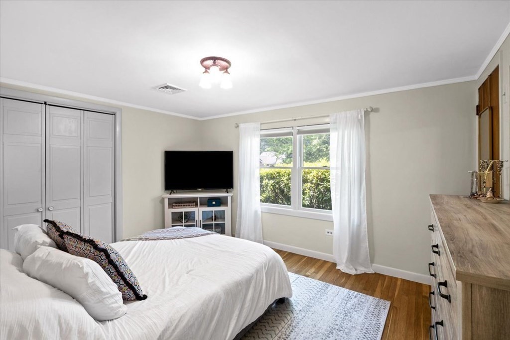 280 Broadway Hanover, MA 02339 - Photo 28 of 37 a bedroom with a bed and a flat screen tv