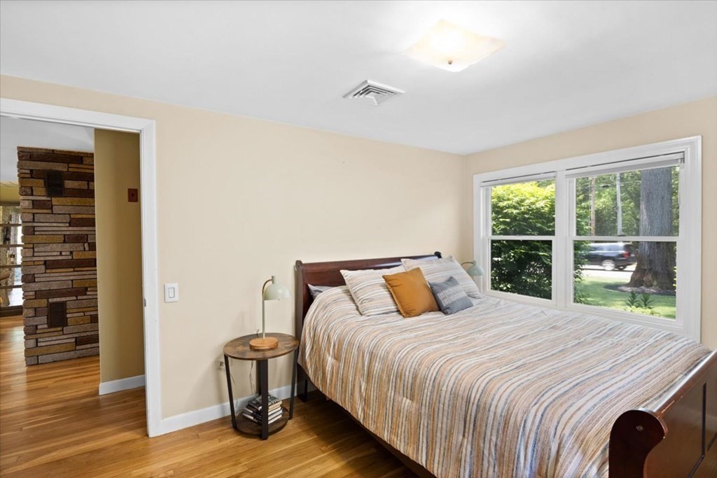 280 Broadway Hanover, MA 02339 - Photo 30 of 37 a bedroom with a bed and wooden floor