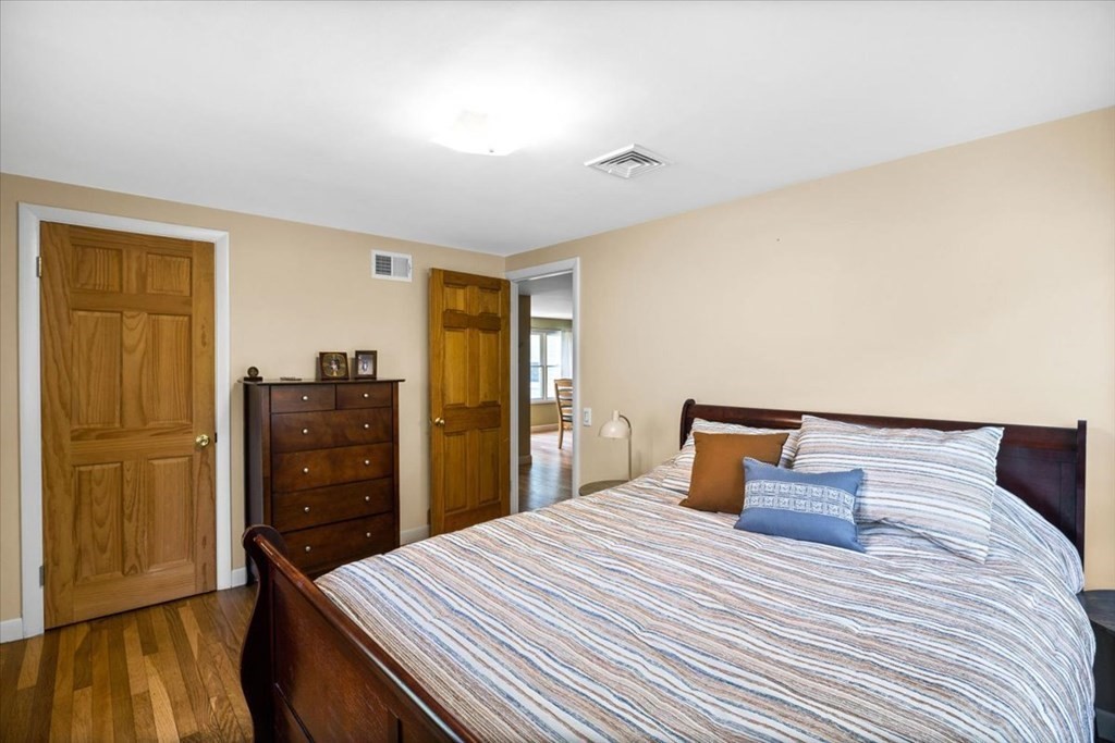 280 Broadway Hanover, MA 02339 - Photo 32 of 37 a bedroom with a bed and wooden floor