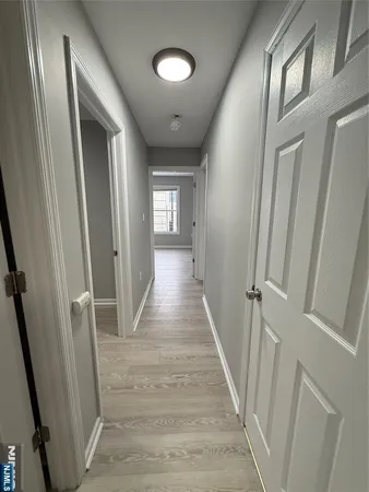 a kitchen with cabinets appliances and a wooden floor
