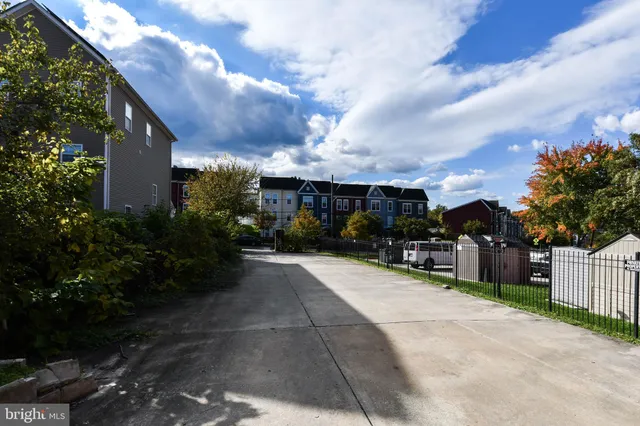 a view of a house with potted plants and a pathway