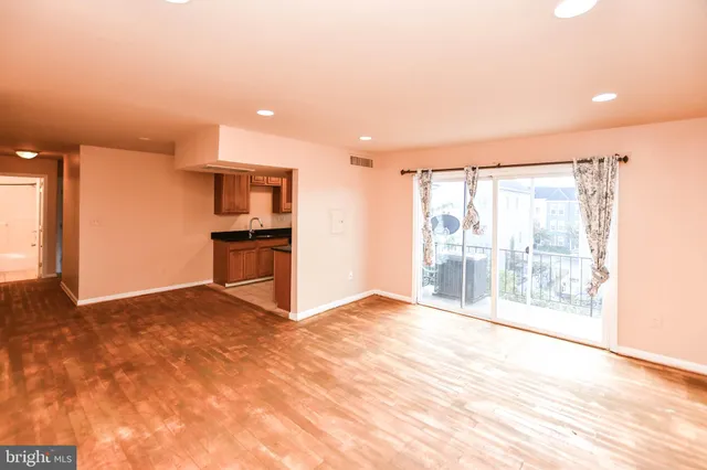 a view of a kitchen with a sink and a refrigerator