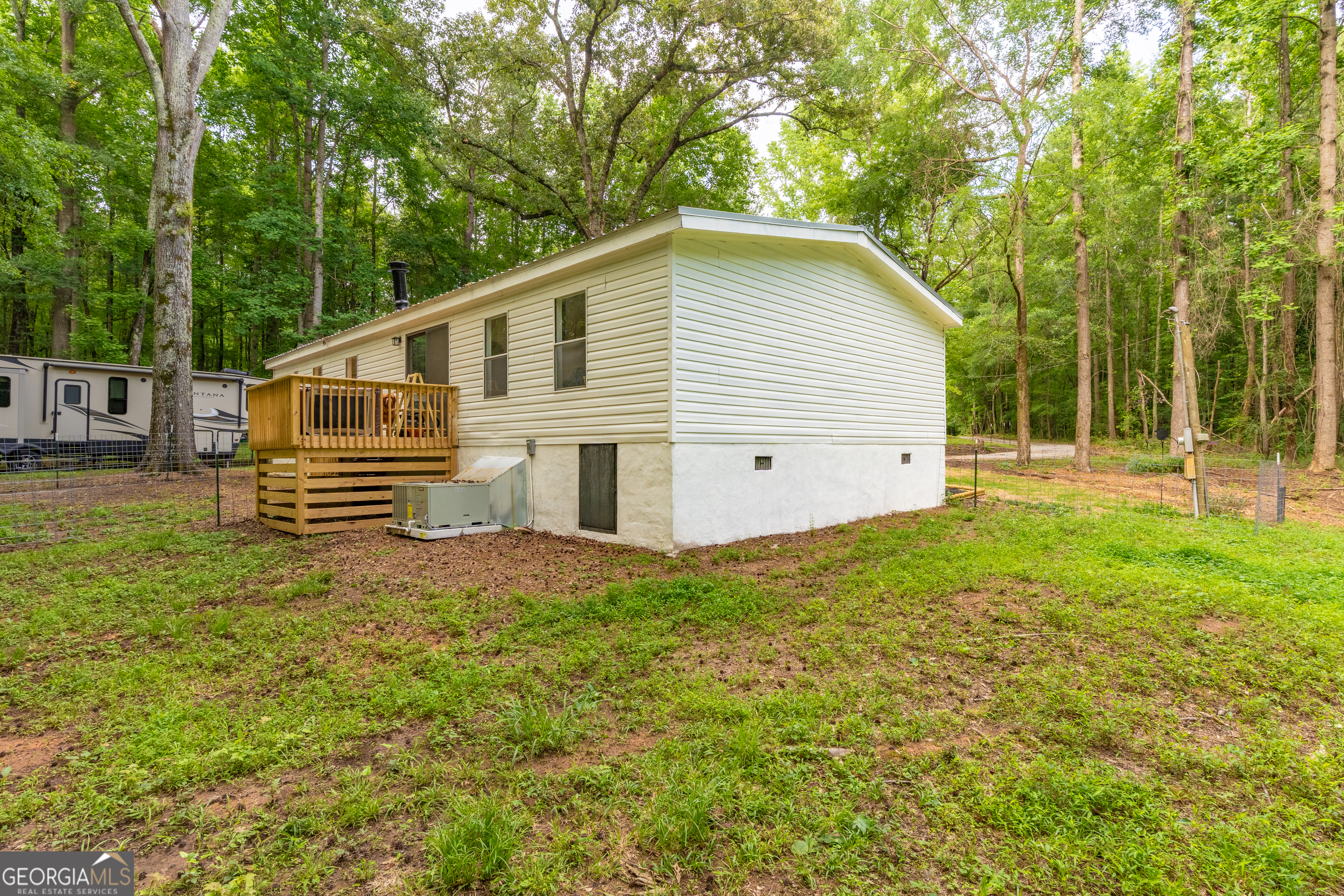 452 Aikenton Road Monticello, GA 31064 - Photo 35 of 47 a view of a house with backyard and trees