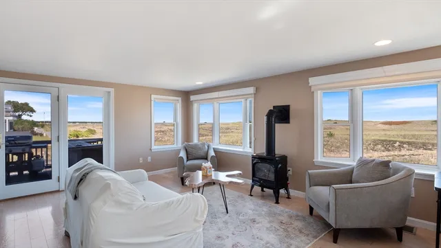 a living room with furniture and large windows