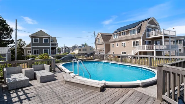 a view of a roof deck with couches and wooden floor