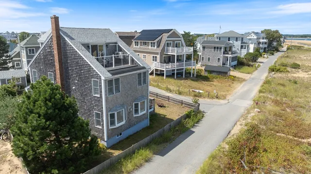 a view of residential houses with yard and mountain view