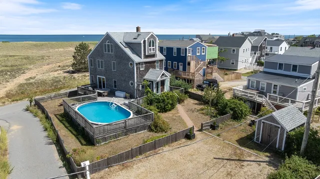 aerial view of a house with swimming pool and ocean view