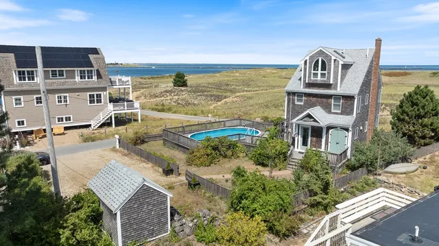 an aerial view of a house with a ocean view
