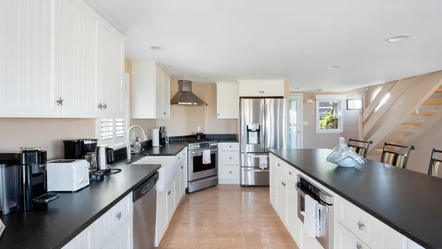 a kitchen with stainless steel appliances granite countertop a sink stove and refrigerator
