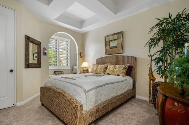 a bedroom with a bed and a potted plant