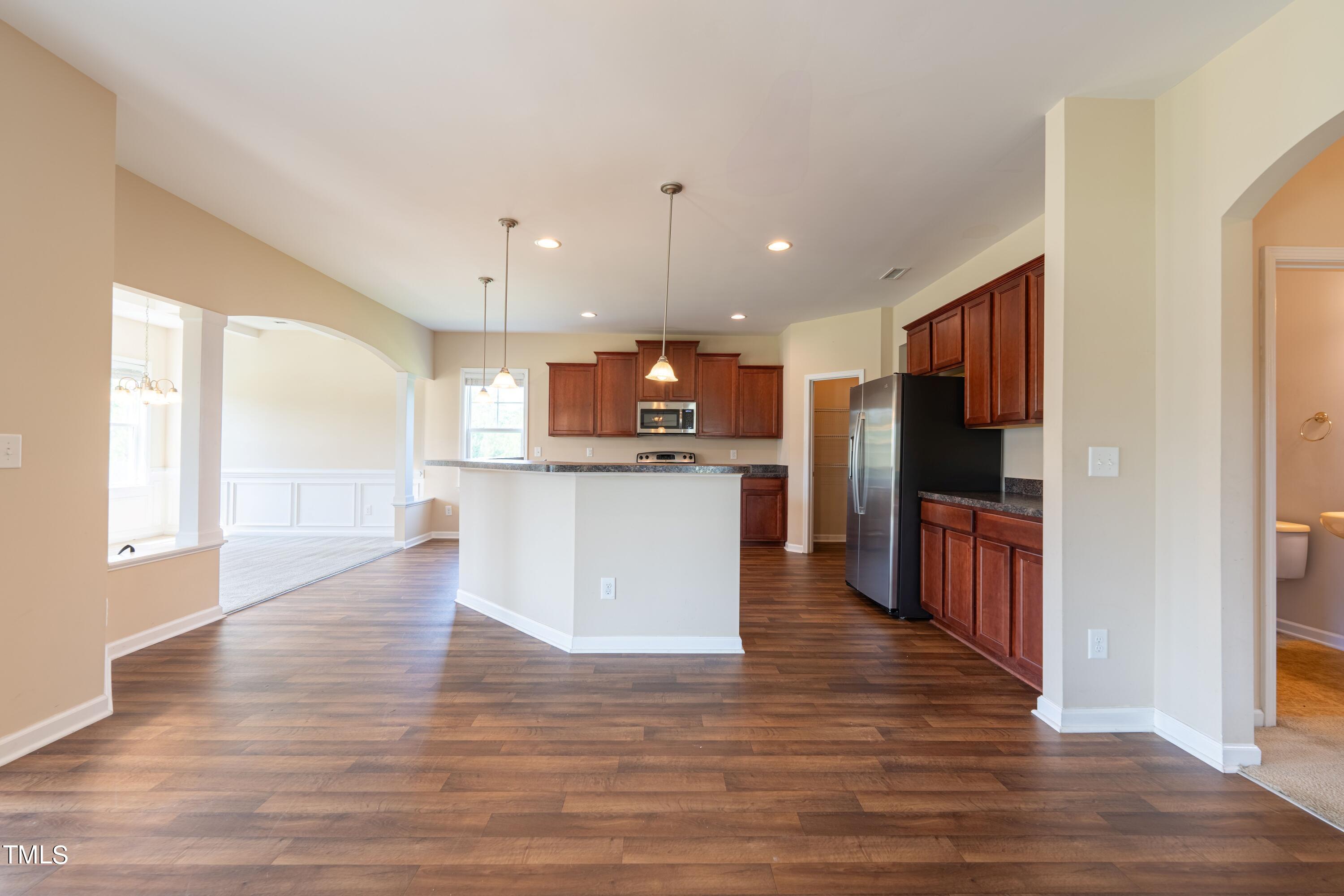 15 Lancaster Court Spring Lake, NC 28390 - Photo 13 of 48 a view of kitchen with kitchen island granite countertop wooden floor stainless steel appliances and cabinets
