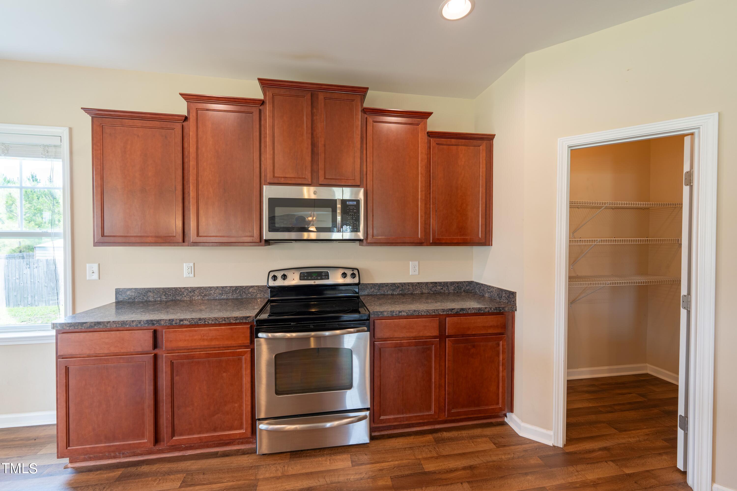 15 Lancaster Court Spring Lake, NC 28390 - Photo 17 of 48 a kitchen with granite countertop wooden cabinets and stainless steel appliances