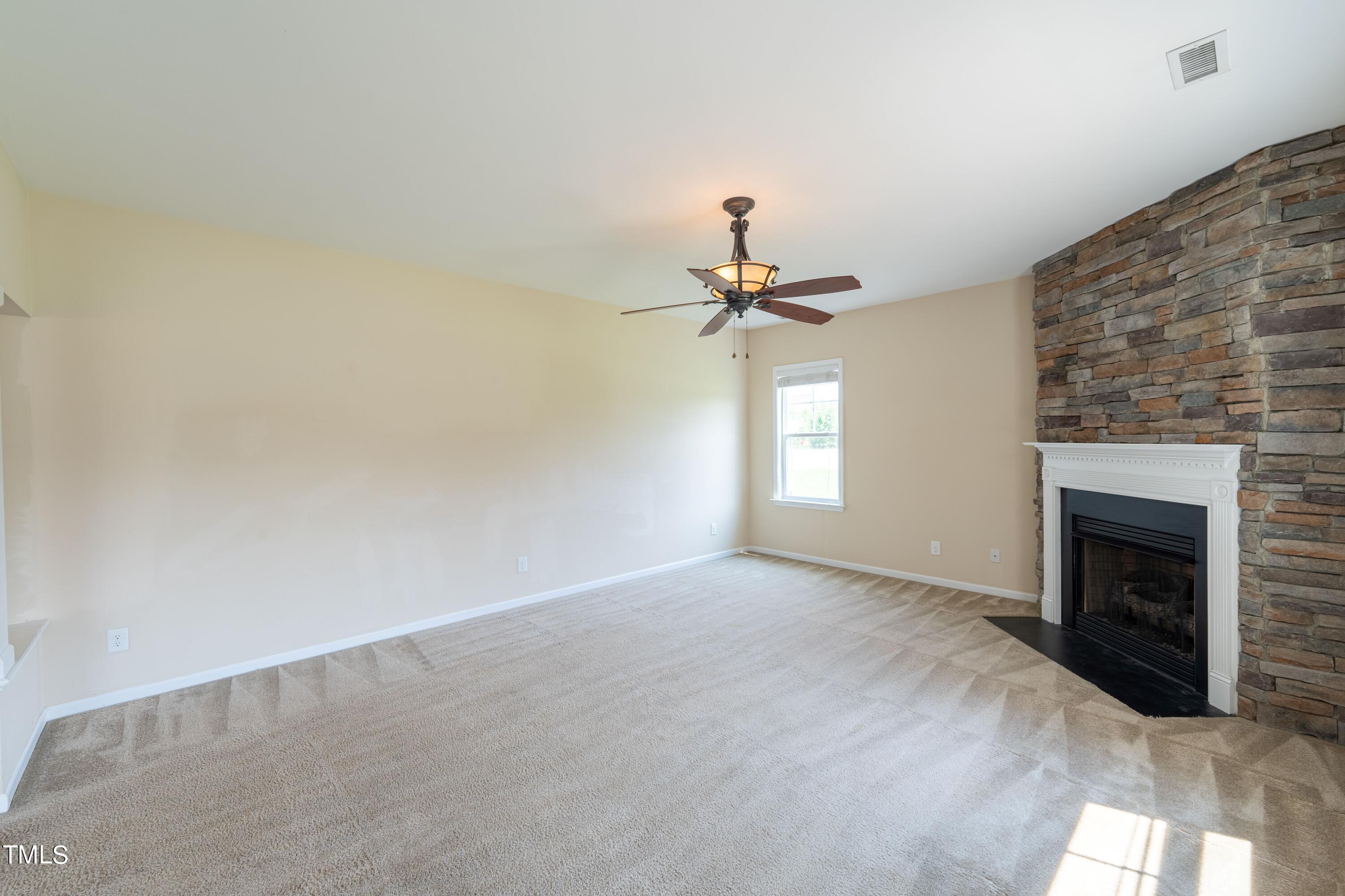 15 Lancaster Court Spring Lake, NC 28390 - Photo 23 of 48 a view of a livingroom with a fireplace and fan