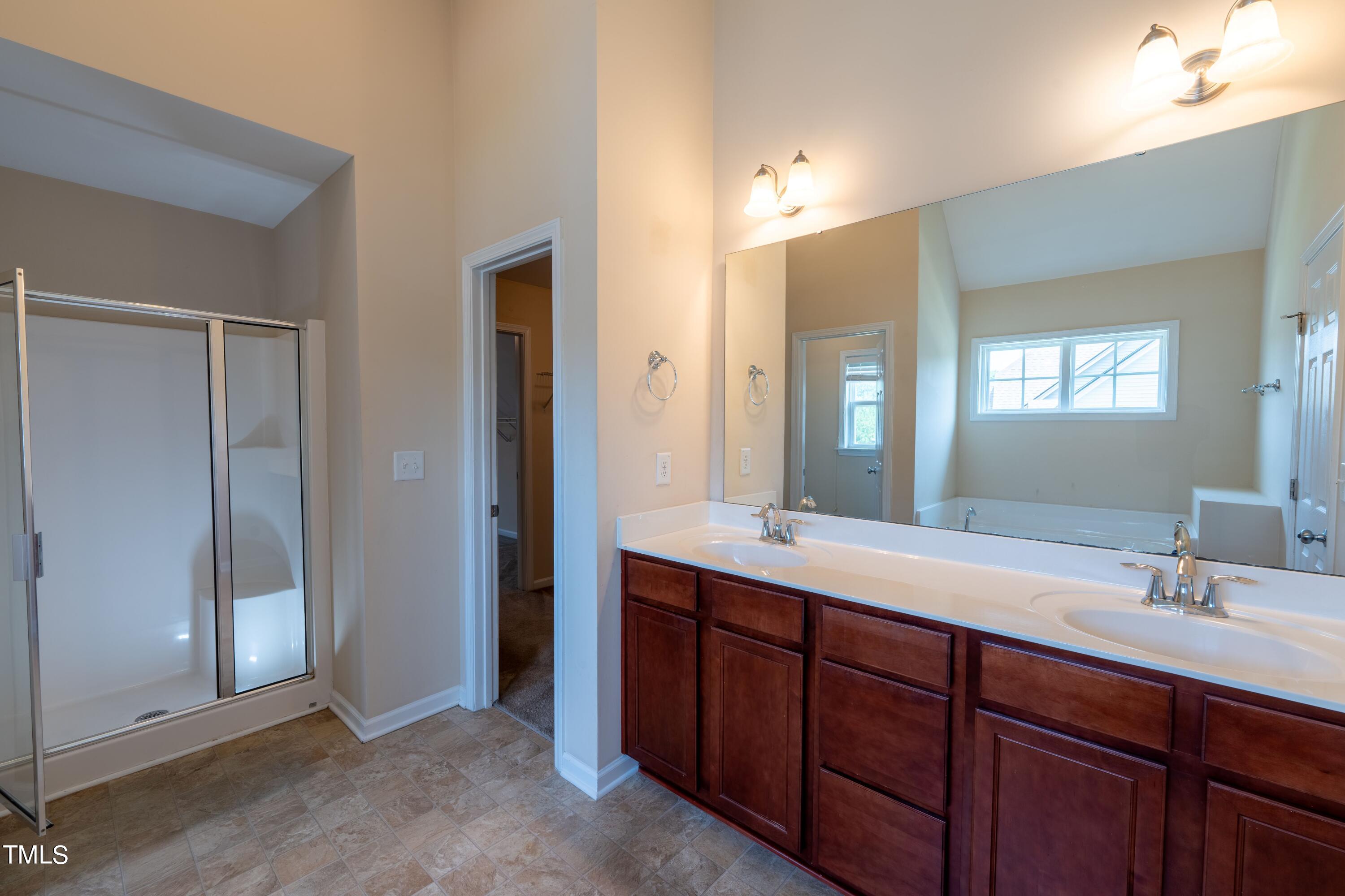 15 Lancaster Court Spring Lake, NC 28390 - Photo 35 of 48 a bathroom with double vanity sinks and a mirror