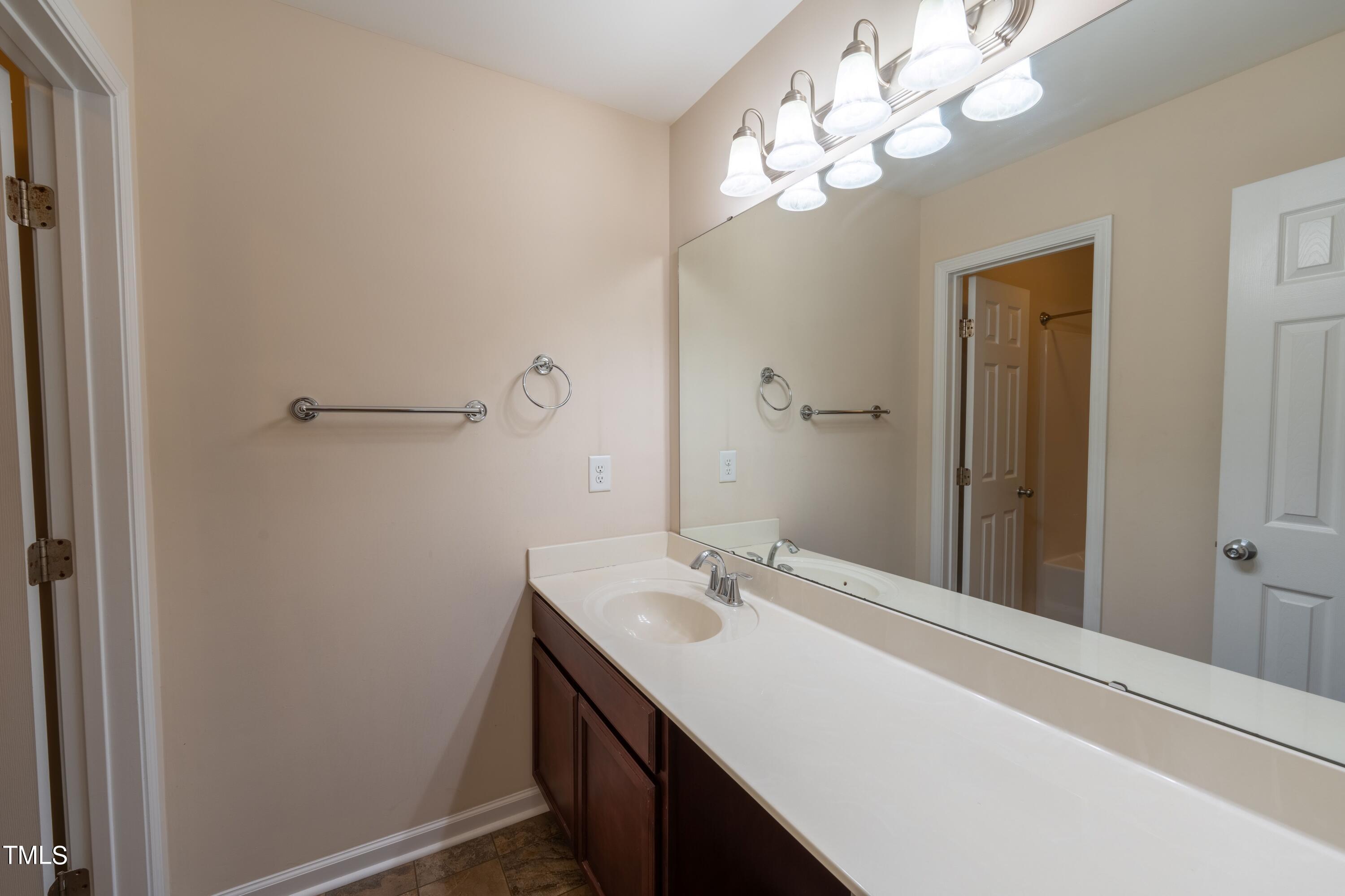 15 Lancaster Court Spring Lake, NC 28390 - Photo 41 of 48 a bathroom with a sink vanity and a mirror