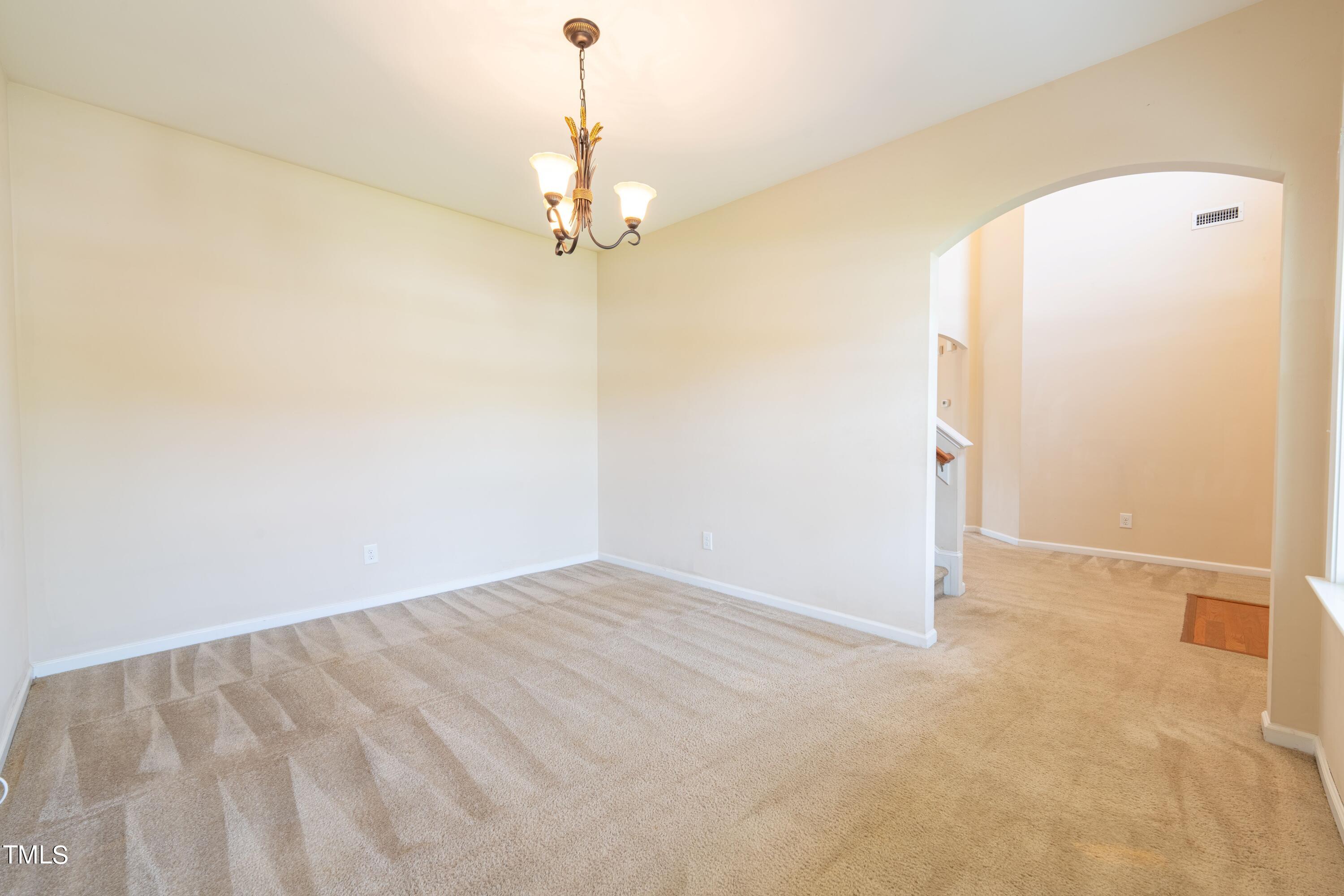 15 Lancaster Court Spring Lake, NC 28390 - Photo 10 of 48 an empty room with a chandelier fan