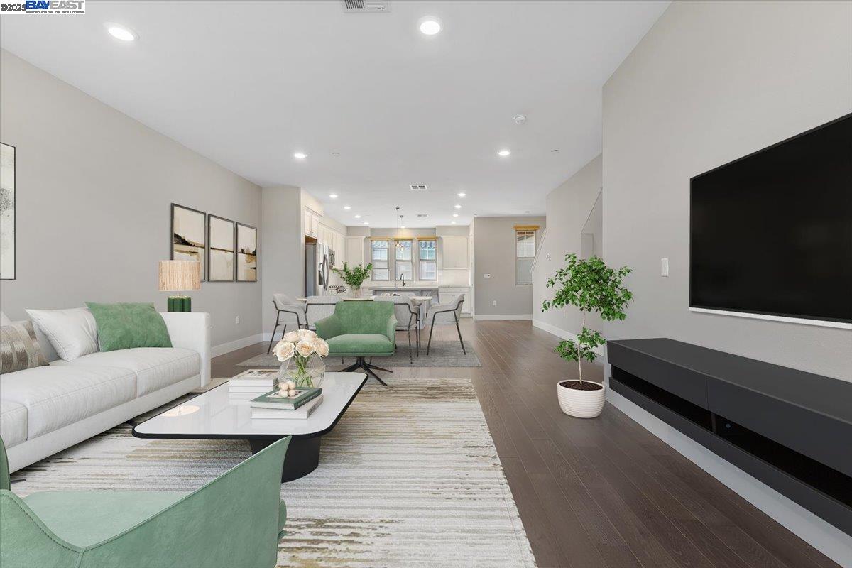a living room with furniture potted plant and a flat screen tv