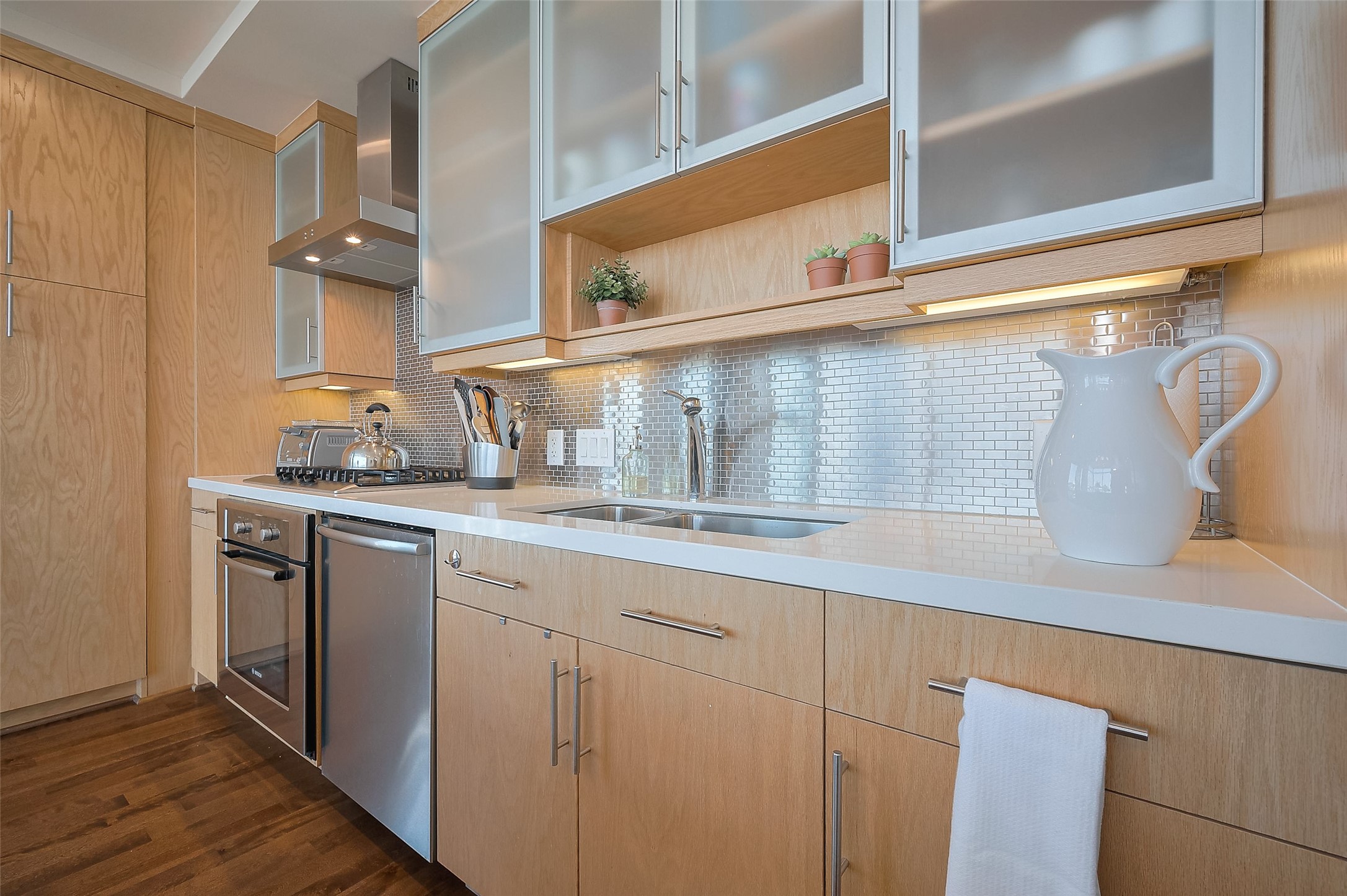 2207 Bancroft Lane, Unit 604 Houston, TX 77027 - Photo 9 of 40 a kitchen with stainless steel appliances a sink and cabinets