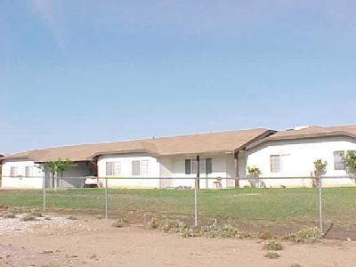 11090 Pinon Avenue Hesperia, CA 92345 - Photo 1 of 1 a front view of a house with a yard