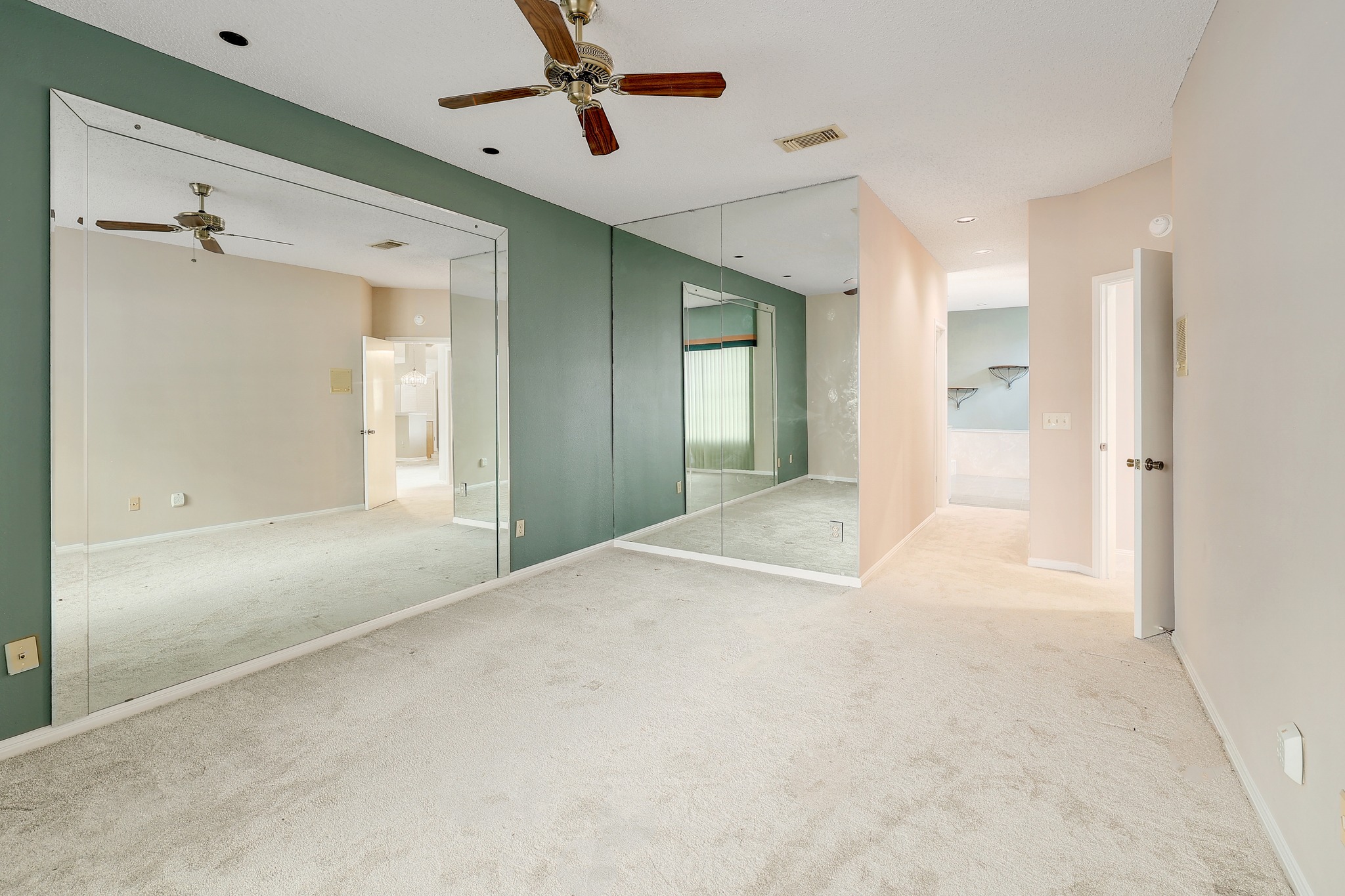 2202 Warfield Way Austin, TX 78728 - Photo 16 of 32 A versatile living area with neutral carpeting and mirrored wall accents.