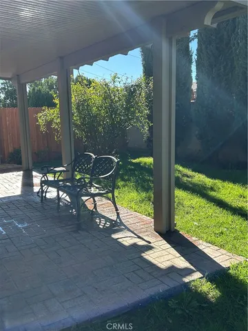 a view of a porch with chairs and a yard
