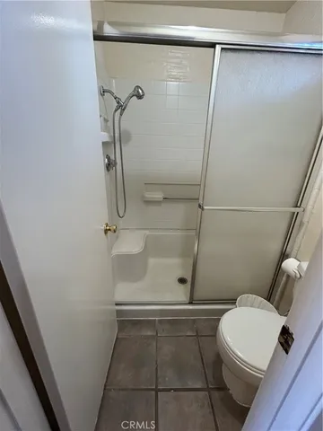 a bathroom with a shower and toilet