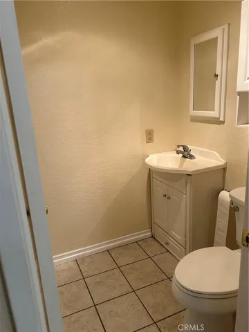 a bathroom with a sink toilet and a mirror