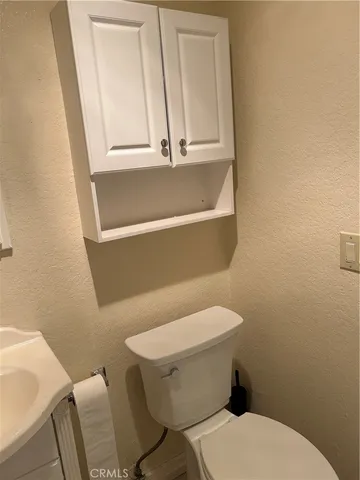 a white toilet sitting next to a sink