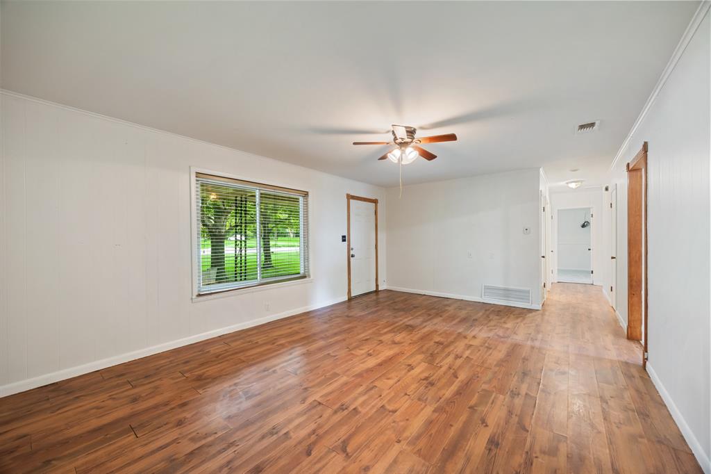 571 South 1st Street Point, TX 75472 - Photo 8 of 27 a view of an empty room with wooden floor and a window