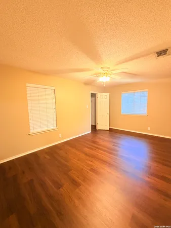 a view of an empty room and a window