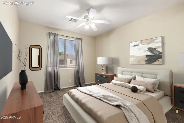 a bedroom with a bed and a painting on the wall