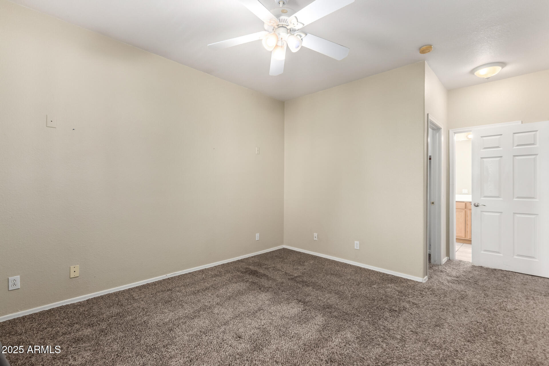 1335 East June Street, Unit 239 Mesa, AZ 85203 - Photo 15 of 34 an empty room with closet and a chandelier fan
