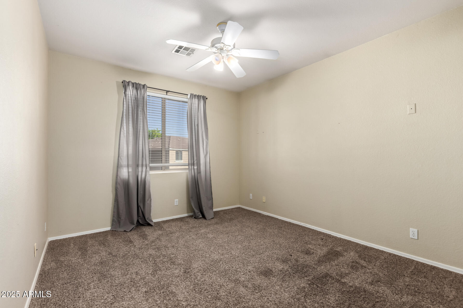 1335 East June Street, Unit 239 Mesa, AZ 85203 - Photo 16 of 34 an empty room with chandelier fan and windows