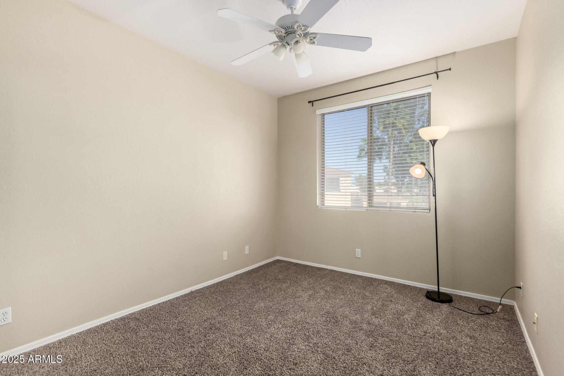 1335 East June Street, Unit 239 Mesa, AZ 85203 - Photo 19 of 34 an empty room with windows and fan