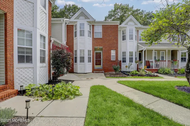 a front view of house with yard and green space