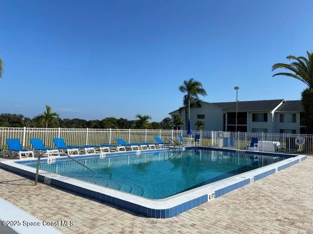 a view of a swimming pool with a lounge chair