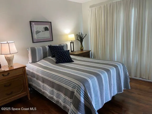 a bedroom with a bed and a night stand