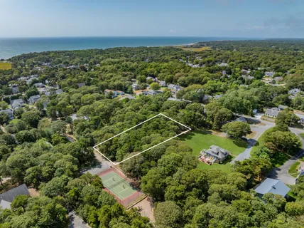 an aerial view of a houses with a yard