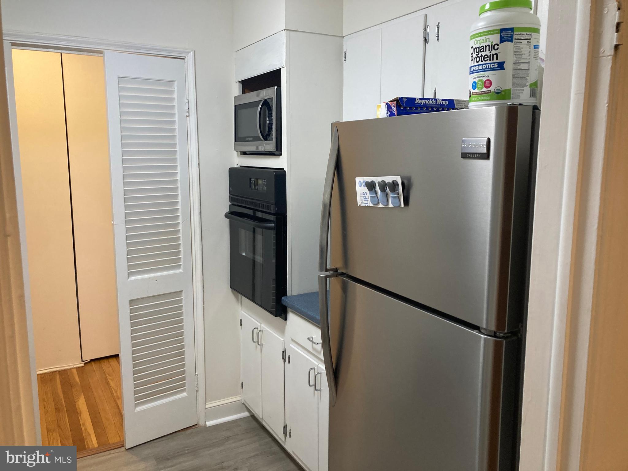 1101 St Paul Street, Unit 1403 Baltimore, MD 21202 - Photo 5 of 13 a refrigerator freezer sitting inside of a kitchen