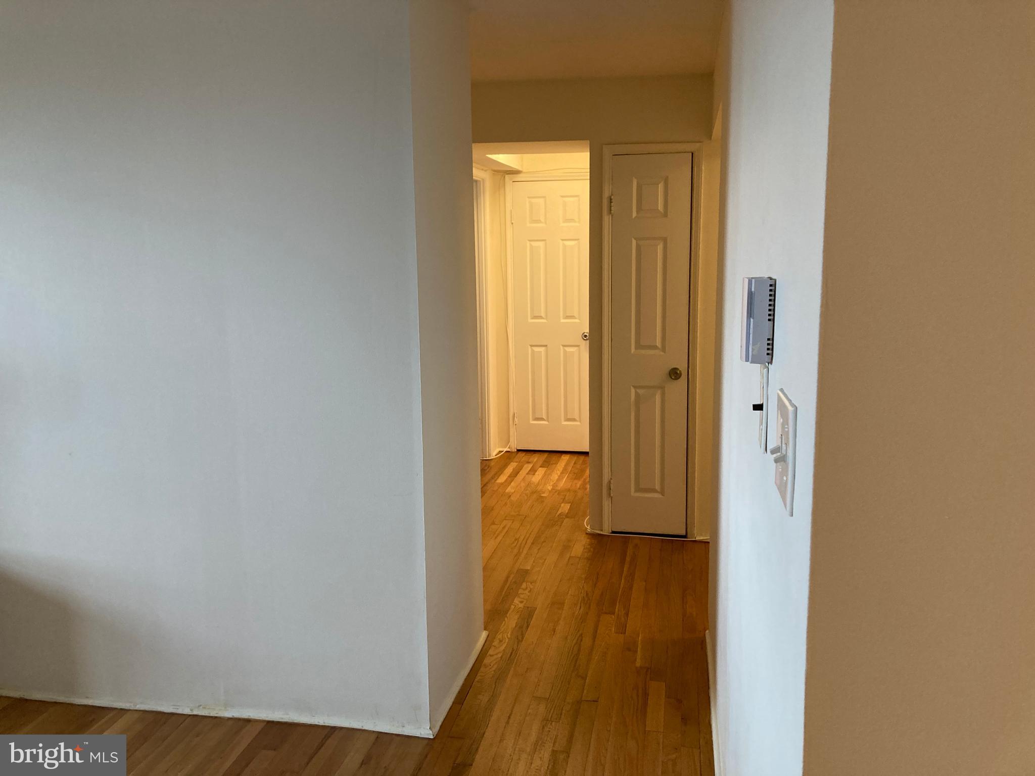 1101 St Paul Street, Unit 1403 Baltimore, MD 21202 - Photo 7 of 13 a view of a hallway with wooden floor